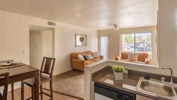 Cantera living room with ceiling fan and carpet